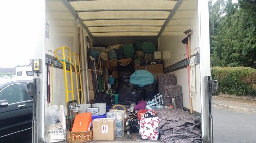Van parked outside commercial premises in Barkingside with waste ready for loading