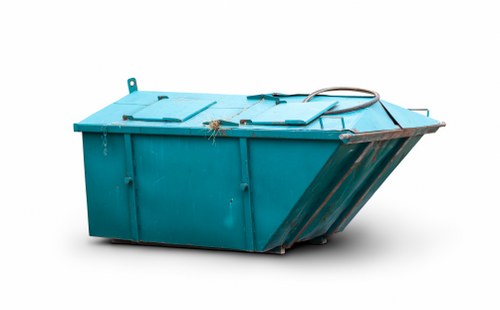 Worker wearing PPE while loading business waste into vehicle